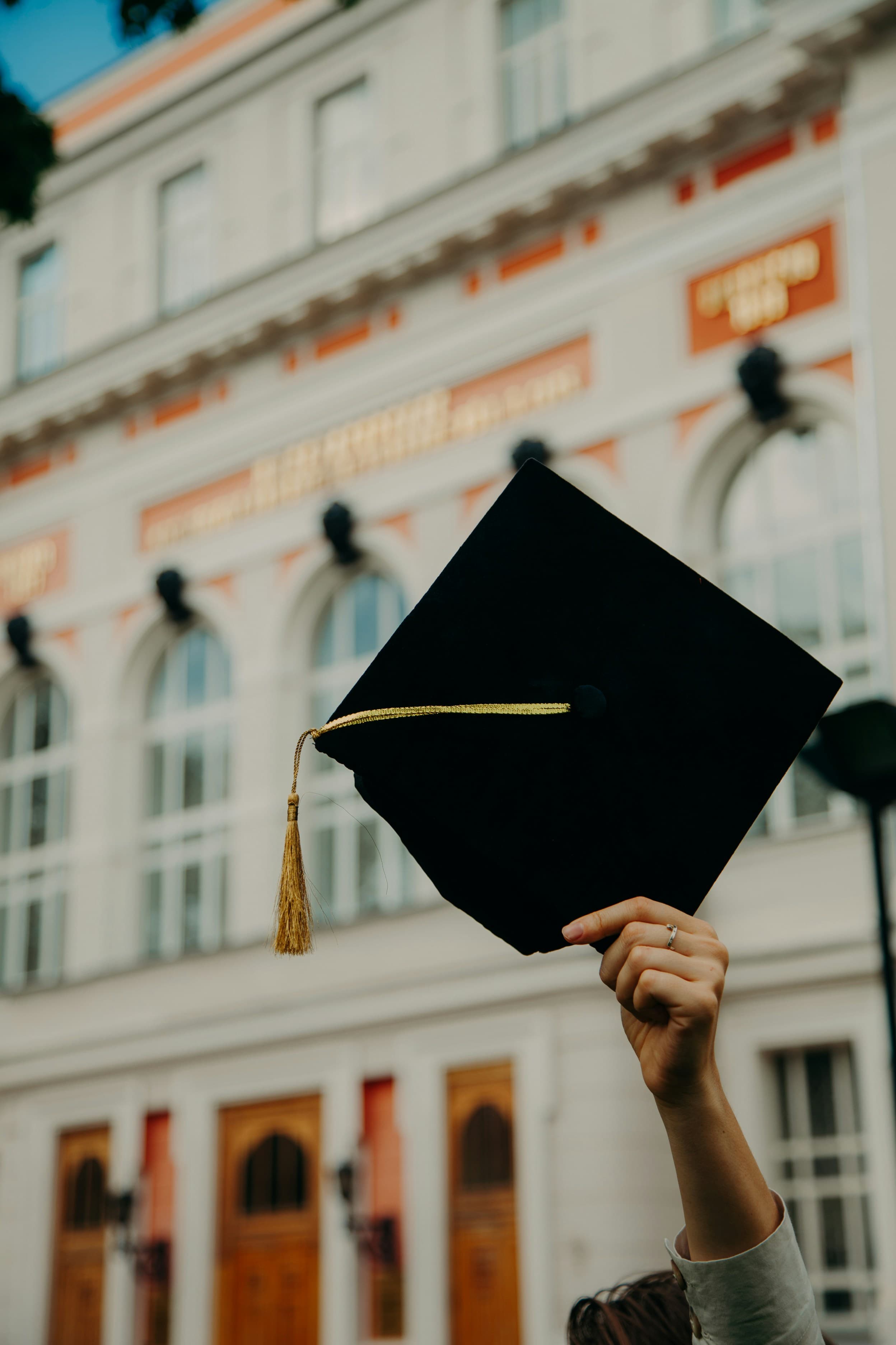A graduation cap held aloft, the destination your child is heading toward